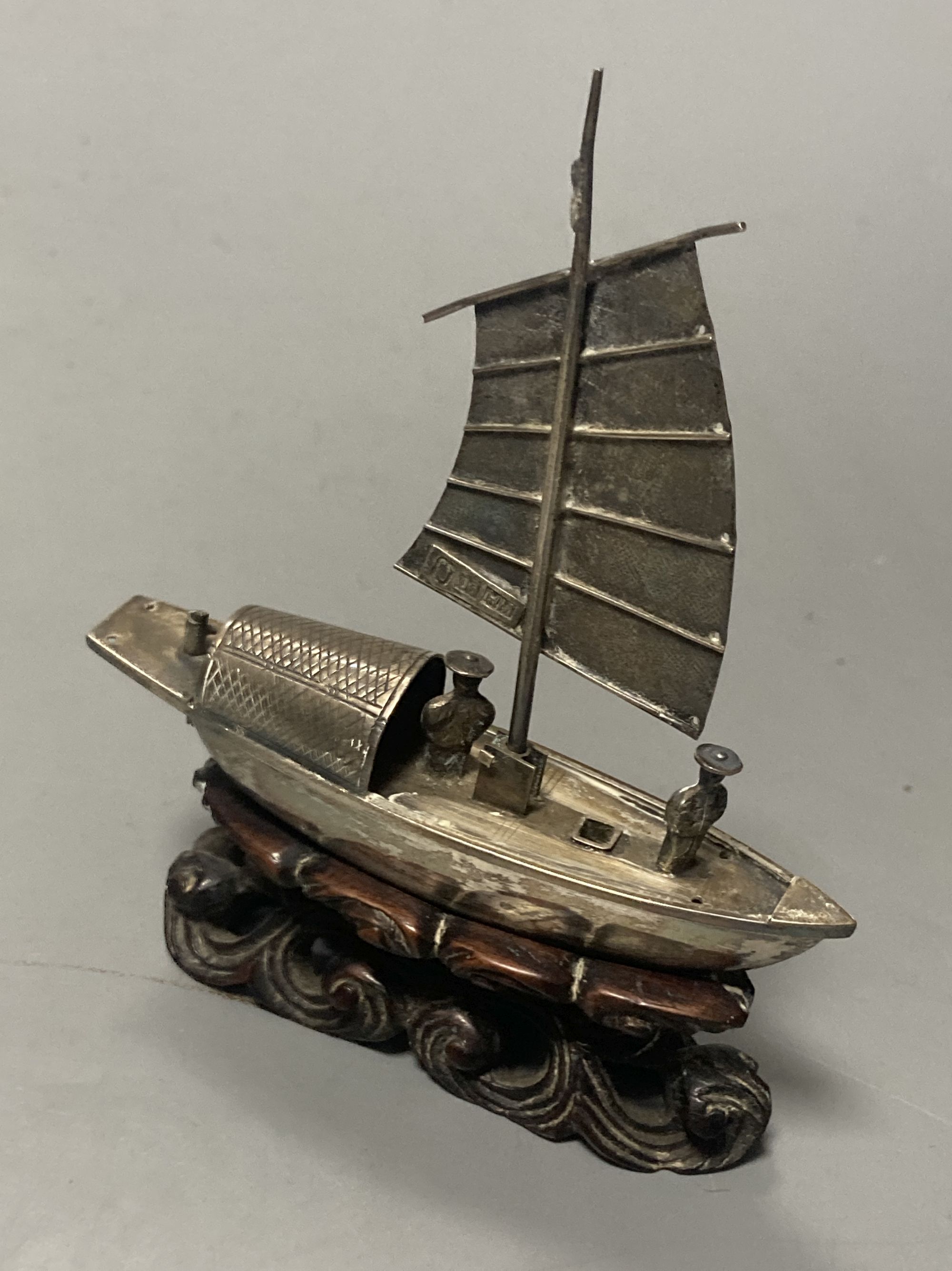 A group of Chinese white metal models of a sampan by Wang Hing, rickshaw and sedan chair etc.